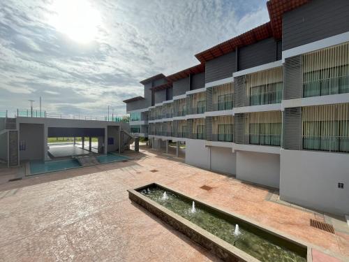 an exterior view of a building with a courtyard at Morib Prosper Resort by uBook in Banting