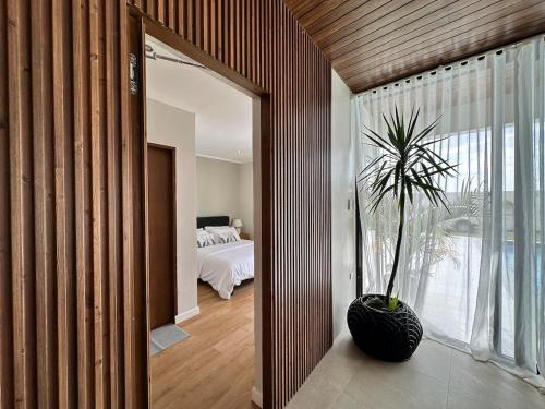 a room with a plant in a vase next to a bedroom at 4BR Villa with Pool in Calatagan Batangas up to 16 Guests in Calatagan