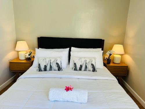 a bedroom with a white bed with a pink bow on it at 4BR Villa with Pool in Calatagan Batangas up to 16 Guests in Calatagan