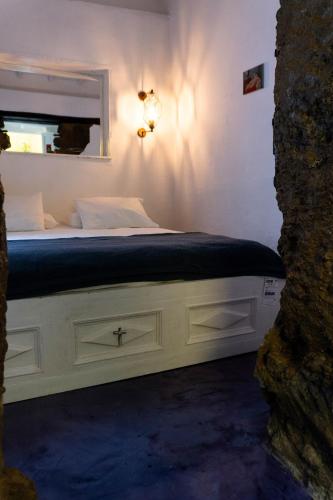 a bedroom with a white bed with a window at Casa Cielo in Concepción