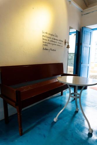 a bench and a table in a room at Casa Cielo in Concepción