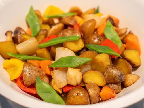 a white bowl of food with mushrooms and vegetables at Urayasu Brighton Hotel Tokyo Bay in Urayasu