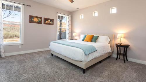 a white bedroom with a bed and a window at Luxury Pet-Friendly Kanab Home Quiet Neighborhood in Kanab