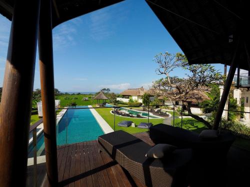 a view of the pool from the deck of a villa at The Samata by LifestyleRetreats in Sanur