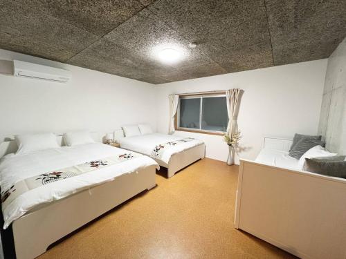 a bedroom with two beds and a window at Sunshine in Tokyo