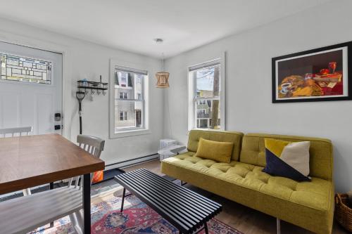 a living room with a couch and a table at Queens Suite 1bdrm in St. John's