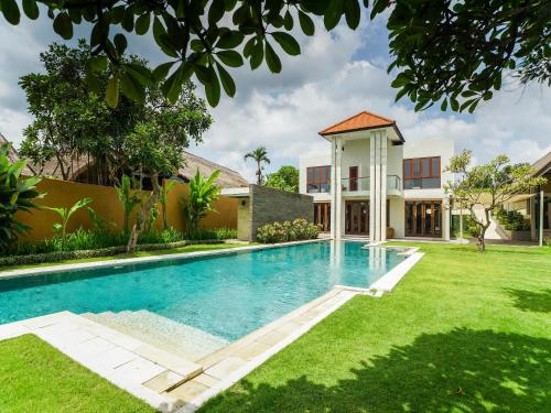 a swimming pool in the yard of a house at The Samata by LifestyleRetreats in Sanur