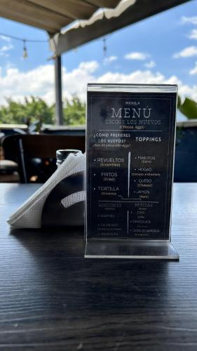 a menu on top of a wooden table at Manila Hotel Boutique in Medellín