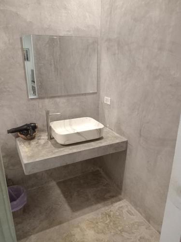 a bathroom with a sink and a mirror at Tropical House​ in Hua Hin