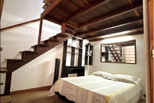 a bedroom with a bed and a staircase at Apto Puerta del Sol in Bucaramanga