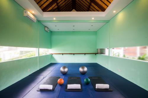 an empty room with three balls on a blue floor at The Samata by LifestyleRetreats in Sanur