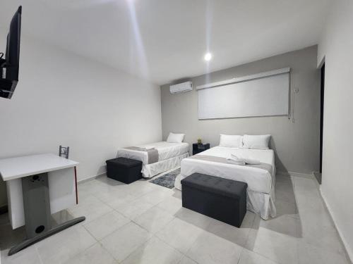 Postel nebo postele na pokoji v ubytování Hotel Suites La Maya
