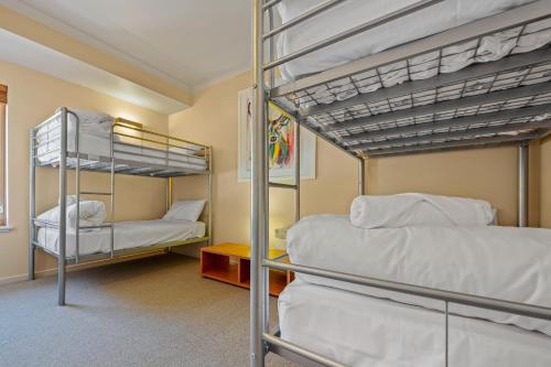a bedroom with two bunk beds and a room at Ski in-Ski out Hotham apt with Parking Undercover in Mount Hotham