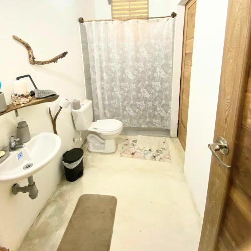 a bathroom with a toilet and a sink at la casablanca moñitos in Moñitos