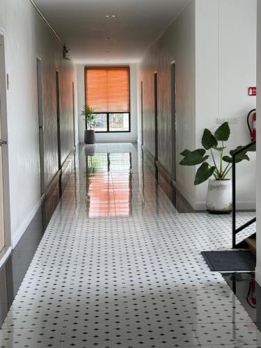 a hallway with a glass floor and a window at Cha V Place Buriram - ชาวีเพลส บุรีรัมย์ in Ban Yang