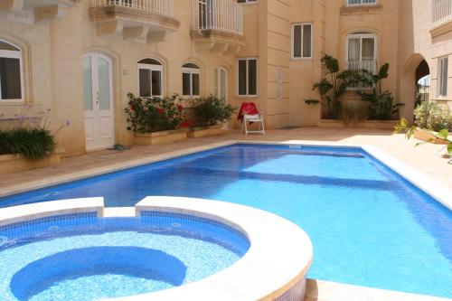 a large swimming pool in front of a building at B3 Misrah Ta Cenc in Sannat