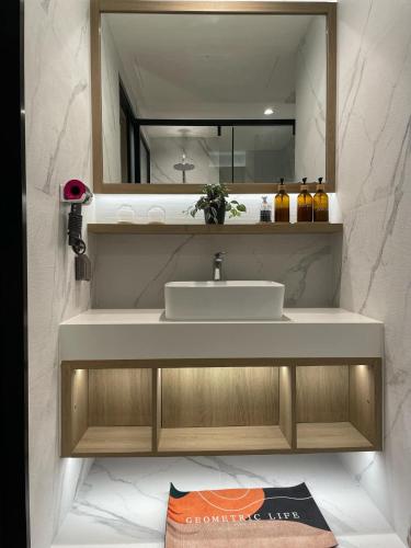 a bathroom with a sink and a mirror at Laya Residence Memoory Layan in Ban Na Bon