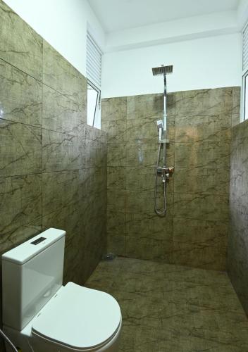 a bathroom with a toilet and a shower at Darigala House in Marapitiya