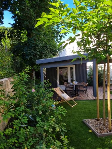 a backyard with a deck and a table and chairs at Bloom Hostel Bar & Garden in Bordeaux