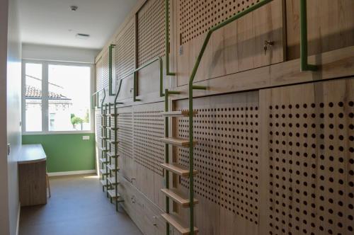 a library with wooden walls and wooden shelves at Bloom Hostel Bar & Garden in Bordeaux