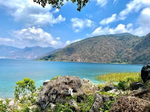 a view of a lake with mountains in the background at Hotel Minnesota y Centro de Eventos Molina in San Lucas Tolimán
