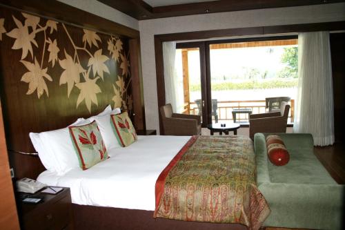 a hotel room with a bed and a window at The LaLit Grand Palace Srinagar in Srinagar