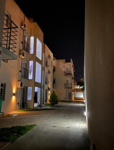 an empty street with two large buildings at night at Enjoy Apart Campana in Campana