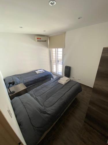 a bedroom with two beds in a room at Enjoy Apart Campana in Campana
