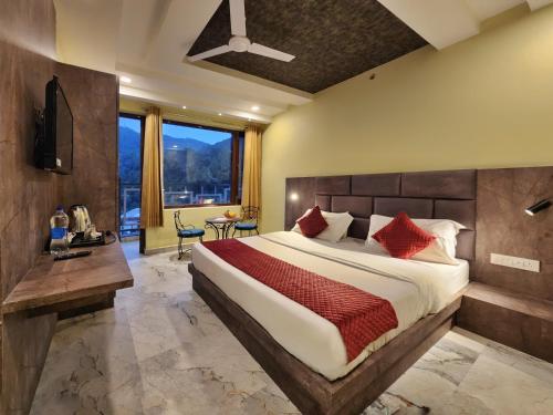 a bedroom with a large bed with red pillows at The White Orchid Dalhousie in Dalhousie