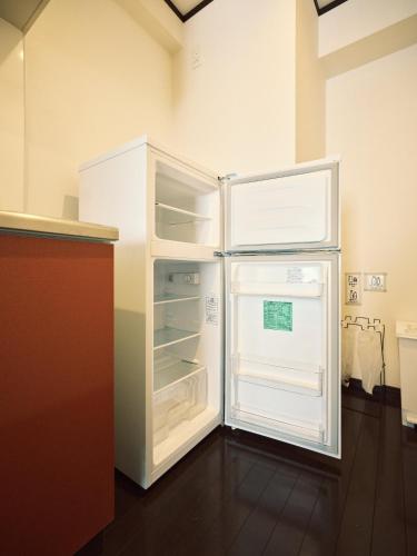 a refrigerator with its door open in a kitchen at vetta Minami-Kumamoto Station 803 in Kumamoto