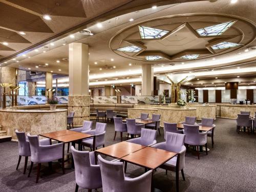 a restaurant with tables and chairs and a bar at Royal Pines Hotel Chiba- Opening in Jan 2025 in Chiba