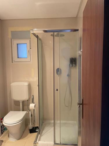 a bathroom with a shower and a toilet at OuraSea Apartment in Albufeira