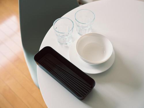 a table with a bowl and glasses on it at vetta kumamoto sakuramachi 603 in Kumamoto