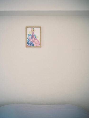 a painting on a white wall in a room at vetta kumamoto sakuramachi 603 in Kumamoto