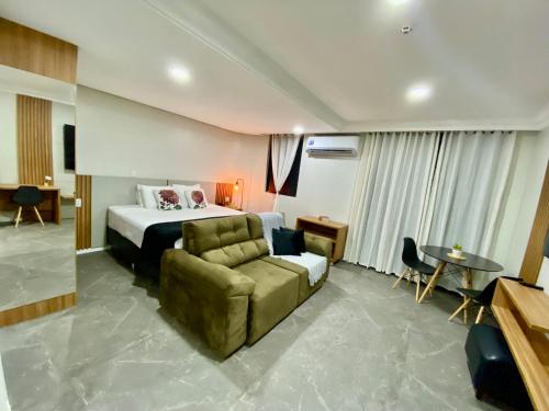 a hotel room with a bed and a couch at Manaus Hotéis Millenium - Flat 206 in Manaus