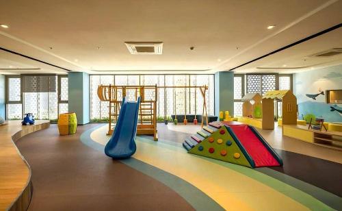 a childrens play room with a slide and a playground at The Song Apartment 5 Stars Vung Tau - Căn Hộ Du Lịch 5 Sao Cạnh Biển - Dumin's Homestay in Vung Tau