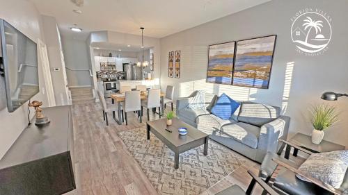 a living room with a couch and a table at Villas at Seven Dwarfs - Close to Disney in Kissimmee