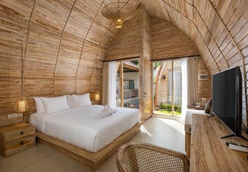 a bedroom with a bed and a tv in a room at Omaneil Villa in Uluwatu