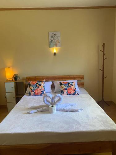 a bedroom with a bed with a cup on it at R&A Haven Guest House in San Juan