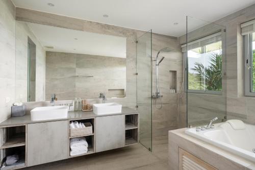 a bathroom with two sinks and a shower at Villa Maliya in Plai Laem