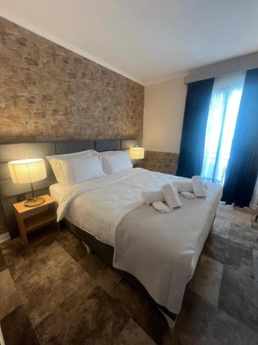 a bedroom with a large bed with two pillows on it at Lighthouse Hotel in Alexandroupoli