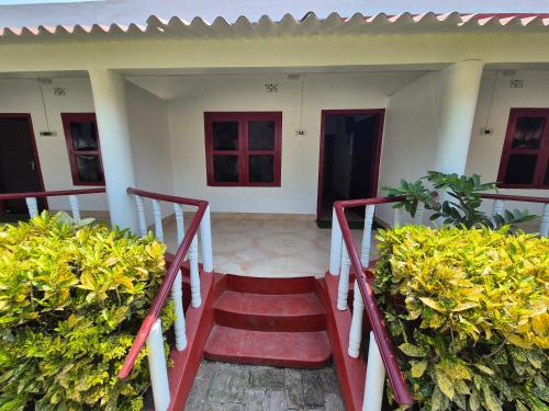 a stairway leading to a house with green plants at Sands Courtyard in Tajpur