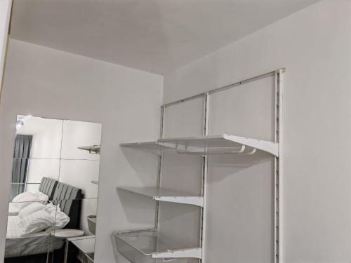 a white room with shelves and a mirror at Urban Loft MRT Convenience KLCC Nearby in EKO CHERAS in Kuala Lumpur