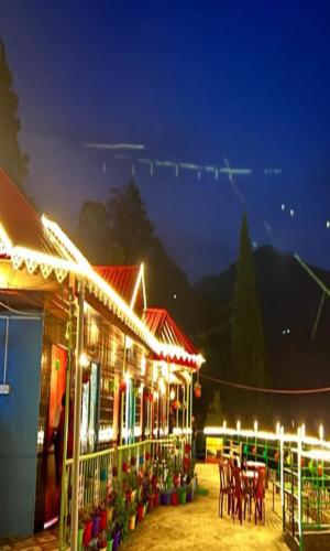 a building with lights on it at night at Nivvana Homestay By StayApart in Lava