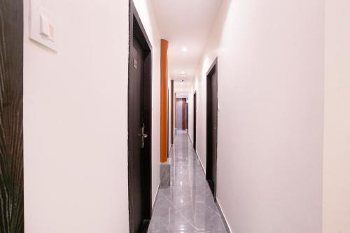 a hallway with white walls and a long aisle at FabHotel Gateway in Mumbai