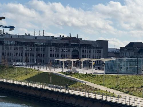a large building next to a river with a bridge at chambre double in Charleroi