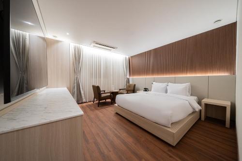 a hotel room with a bed and a desk at Guwol Rondo Hotel in Incheon