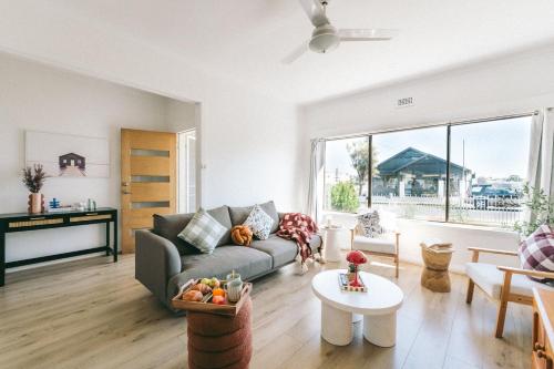 a living room with a couch and a table at Hobart Riverside Cosy 4BR - 10mins to Hobart CBD in Hobart