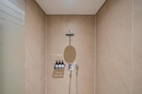 a bathroom with a shower with a phone in it at Guwol Rondo Hotel in Incheon
