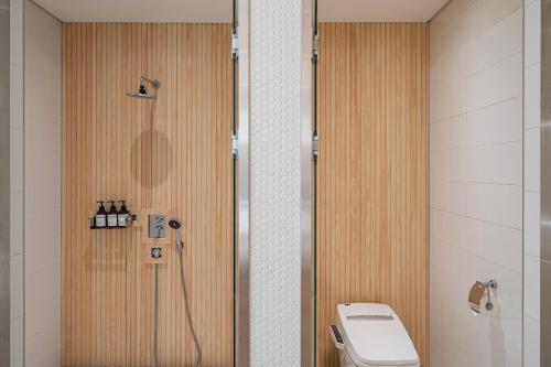 a bathroom with a shower and a toilet in it at Guwol Rondo Hotel in Incheon